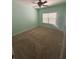 An empty bedroom with neutral carpet, a ceiling fan and a window with natural light at 1038 Island View Ct, Buford, GA 30518