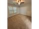Bright bedroom offers a cozy atmosphere with a window for natural light and plush carpeting at 1038 Island View Ct, Buford, GA 30518