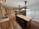 A kitchen featuring custom cabinets, granite countertops, hardwood floors, and stainless steel appliances at 1038 Island View Ct, Buford, GA 30518