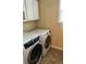 Laundry room with white washer and dryer and tile flooring at 1038 Island View Ct, Buford, GA 30518