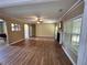 Spacious living room with hardwood floors, fireplace, and large windows providing natural light at 1038 Island View Ct, Buford, GA 30518