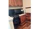 Home office with hardwood flooring, custom cabinets, and dual monitors atop a desk at 1038 Island View Ct, Buford, GA 30518