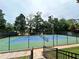 A community tennis court surrounded by trees, providing an active and engaging recreational space at 1038 Island View Ct, Buford, GA 30518