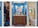 Updated bathroom with a dark vanity cabinet with drawer storage and a neutral colored tile toilet room at 5360 Fieldgreen Dr, Stone Mountain, GA 30088