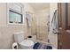 Bathroom showcasing a glass shower, toilet, and window providing natural light at 5360 Fieldgreen Dr, Stone Mountain, GA 30088