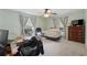 Well-lit bedroom with large windows, carpet, and dark wood dresser at 5360 Fieldgreen Dr, Stone Mountain, GA 30088