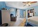 Bright bedroom features blue walls, carpet, ceiling fan, and closet with lots of storage space at 5360 Fieldgreen Dr, Stone Mountain, GA 30088