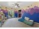 ' bedroom with colorful space-themed wall art, carpeted floors, and a ceiling fan at 5360 Fieldgreen Dr, Stone Mountain, GA 30088