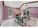 Bright dining room featuring high ceilings with exposed beams and a modern table at 5360 Fieldgreen Dr, Stone Mountain, GA 30088