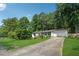 Expansive front yard view of a well-maintained home with lush landscaping and a long driveway at 5360 Fieldgreen Dr, Stone Mountain, GA 30088