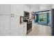 Bright kitchen with white cabinets and stainless steel appliances overlooking breakfast area at 5360 Fieldgreen Dr, Stone Mountain, GA 30088