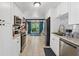 Well-lit kitchen with white cabinets, stainless steel appliances, and granite countertops at 5360 Fieldgreen Dr, Stone Mountain, GA 30088