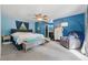 Bedroom featuring blue walls, carpeted floors, and a ceiling fan with a seating area at 5360 Fieldgreen Dr, Stone Mountain, GA 30088