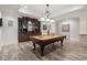 Recreational basement showcasing a pool table and full wet bar for entertaining guests at 6325 Haddington Ln, Suwanee, GA 30024