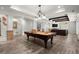 Finished basement featuring a pool table, entertainment area, and painted columns with brick accents at 6325 Haddington Ln, Suwanee, GA 30024