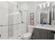 Well-lit bathroom featuring a glass shower, decorative tile backsplash, granite vanity, and modern fixtures at 6325 Haddington Ln, Suwanee, GA 30024