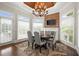 Bright breakfast nook with views of backyard, custom lighting, fireplace, and wood accents at 6325 Haddington Ln, Suwanee, GA 30024