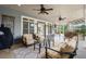 Relaxing covered patio with ceiling fans, comfortable seating and an outdoor kitchen at 6325 Haddington Ln, Suwanee, GA 30024