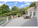 Outdoor deck features a dining area overlooking a pool and wooded backyard at 6325 Haddington Ln, Suwanee, GA 30024