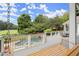 Spacious deck overlooking a pool and lush green backyard with trees and a seating swing at 6325 Haddington Ln, Suwanee, GA 30024
