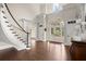 Grand foyer with staircase, hardwood floors, and elegant architectural details at 6325 Haddington Ln, Suwanee, GA 30024