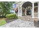 Close up of the front of the home, showing the stone porch, columns, and double front doors at 6325 Haddington Ln, Suwanee, GA 30024