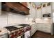 Gourmet kitchen with stainless steel stove, custom cabinets, marble backsplash and professional grade appliances at 6325 Haddington Ln, Suwanee, GA 30024