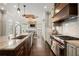 Open kitchen with stainless steel appliances, large island, marble countertops and a breakfast nook at 6325 Haddington Ln, Suwanee, GA 30024