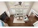 Aerial view of a living room with floor to ceiling windows and a large sectional couch at 6325 Haddington Ln, Suwanee, GA 30024