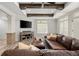 Bright living room featuring a comfortable couch, large windows and a modern entertainment center at 6325 Haddington Ln, Suwanee, GA 30024
