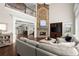 Open-concept living room with stone fireplace, high ceilings, hardwood floors, and comfortable seating at 6325 Haddington Ln, Suwanee, GA 30024