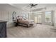 Spacious main bedroom featuring an ensuite bathroom, large windows and plush carpeting at 6325 Haddington Ln, Suwanee, GA 30024
