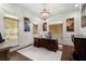 Office featuring dark wood accents, panelled walls, neutral colors, modern chandelier, and a large desk at 6325 Haddington Ln, Suwanee, GA 30024