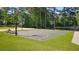 Outdoor basketball court on a well-manicured lawn, featuring modern hoops, a volleyball net and picnic area at 1518 Maplewood Ct, Woodstock, GA 30189