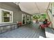 Covered patio area with seating and view of the wooded surroundings at 1518 Maplewood Ct, Woodstock, GA 30189