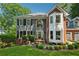 Charming two-story home boasts mature landscaping, grey siding, and a two-car garage at 1518 Maplewood Ct, Woodstock, GA 30189