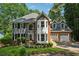 Charming two-story home boasts mature landscaping, grey siding, and a two-car garage at 1518 Maplewood Ct, Woodstock, GA 30189