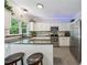 Modern kitchen features white cabinets, stainless steel appliances, and granite countertops at 1518 Maplewood Ct, Woodstock, GA 30189