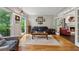 A cozy living room with hardwood floors, large windows, and decorative chandelier at 1518 Maplewood Ct, Woodstock, GA 30189