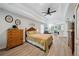 Spacious main bedroom with tray ceiling, wood-look flooring, and comfortable sitting area at 1518 Maplewood Ct, Woodstock, GA 30189