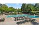 Large community pool with plenty of seating and umbrellas at 1518 Maplewood Ct, Woodstock, GA 30189
