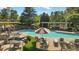 Community pool area with lounge chairs and umbrellas at 1518 Maplewood Ct, Woodstock, GA 30189