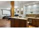 Entertainer's bar with custom wood finishes, granite counters, pendant lighting, and ample storage at 410 Waterridge Ct, Sandy Springs, GA 30350