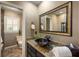 Stylish bathroom with granite countertop, vessel sink, framed mirror, and window shutters at 410 Waterridge Ct, Sandy Springs, GA 30350
