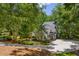 Beautiful home with mature trees, a circular driveway, and lush landscaping at 410 Waterridge Ct, Sandy Springs, GA 30350