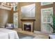 Main bedroom fireplace with decorative mantle, detailed trim, and neutral carpet at 410 Waterridge Ct, Sandy Springs, GA 30350