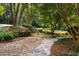 Stunning landscaping featuring stone walkway, rock garden, and mature trees at 410 Waterridge Ct, Sandy Springs, GA 30350