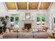 Cozy living room featuring a fireplace, large windows, and comfortable seating at 410 Waterridge Ct, Sandy Springs, GA 30350