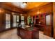 Executive office featuring wood paneling, custom built-ins, and natural light from a large bay window at 410 Waterridge Ct, Sandy Springs, GA 30350