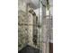 Modern shower with river rock floor, stone tile, towel warmer, and multi-setting shower head at 410 Waterridge Ct, Sandy Springs, GA 30350